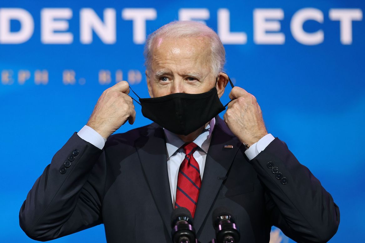 US President-elect Joe Biden removes his face mask before <a href="https://www.cnn.com/2020/12/08/politics/joe-biden-introduces-health-team/index.html" target="_blank">he introduced the top members of his health team</a> on Tuesday, December 8.