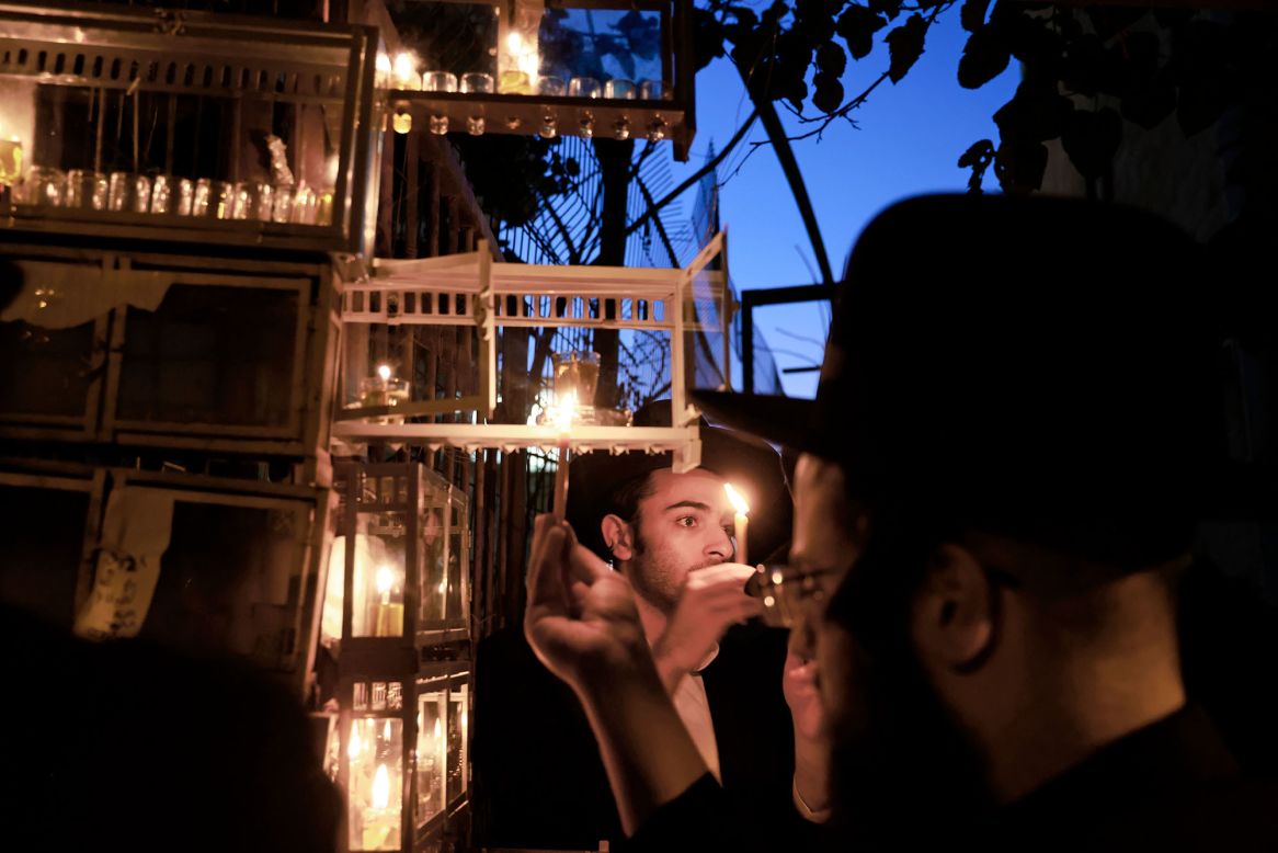 Ultra-Orthodox Jewish men light candles in Jerusalem on Thursday, December 10, the first night of Hanukkah.