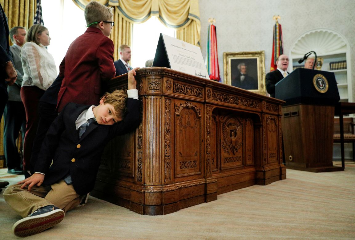 Sammy Olszta, the 6-year-old grandson of wrestling legend Dan Gable, leans against the Resolute Desk inside the White House Oval Office on Monday, December 7. Gable was speaking beside US President Donald Trump during a ceremony where <a href="https://www.cnn.com/2020/12/07/politics/donald-trump-dan-gable-medal-of-freedom/index.html" target="_blank">he received the Presidential Medal of Freedom.</a> 
