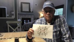 Michael Esmond shows the holiday card he sent to the 36 families in Gulf Breeze, Florida