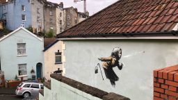 Graffiti artwork - Bristol. Graffiti that has appeared on a wall in Vale Street, Bristol, which could be the latest artwork from street artist Banksy, though the elusive street artist is yet to confirm whether he painted the mural. Picture date: Thursday December 10, 2020. The piece depicts a woman in a head scarf sneezing and losing her false teeth. See PA story ARTS Banksy. Photo credit should read: Claire Hayhurst/PA Wire URN:57035584 (Press Association via AP Images)