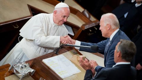 Pope Francis greets then-Vice President Joe Biden, center, and Speaker John Boehner, R-Ohio, in the House chamber of the US Capitol before he addressed a joint meeting of Congress, September 24, 2015.