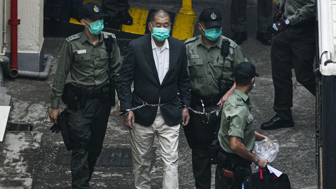 HONG KONG, CHINA - DECEMBER 12: Hong Kong media tycoon Jimmy Lai, founder and owner of Apple Daily newspaper is seen handcuffed and escorted by the guards leaving Lai Chi Kok Reception Centre on December 12, 2020 in Hong Kong, China. Lai is accused of collusion with foreign forces to endanger national security, an offence that carries a maximum penalty of life imprisonment. (Photo by Keith Tsuji/Getty Images)