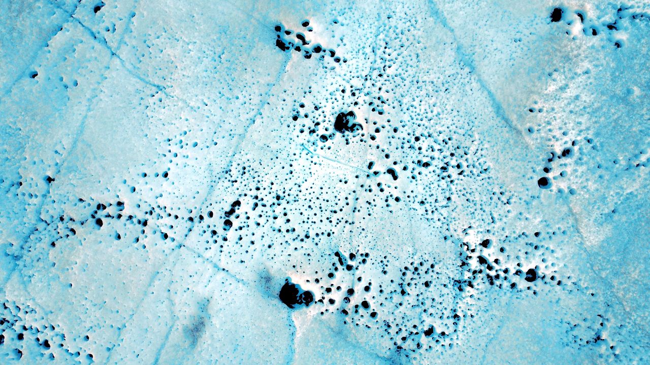 Melt holes caused by bacteria are another threat to Greenland's ice sheet. The largest of these is approximately 20 inches in diameter.