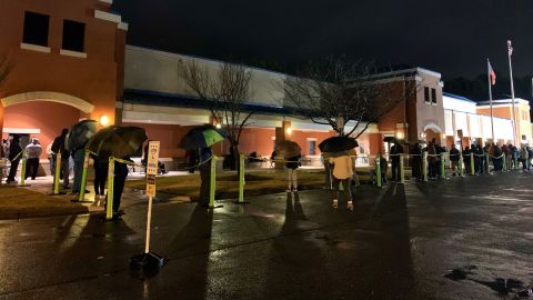 Lines of early voters in Marietta, Georgia, started forming before the sun was up Monday morning despite rainy and blustery weather. People wrapped themselves in blankets, carried umbrellas and huddled under lawn chairs.