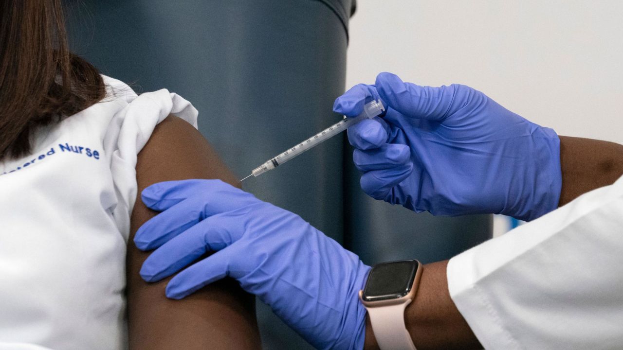 Sandra Lindsay is inoculated with the Pfizer-BioNTech Covid-19 vaccine by Dr. Michelle Chester.