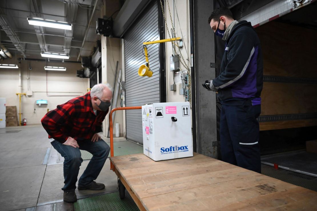 Minnesota Gov. Tim Walz inspects the first delivery of the Pfizer-BioNTech COVID-19 vaccines to the Minneapolis VA Hospital on Monday, Dec. 14, 2020.