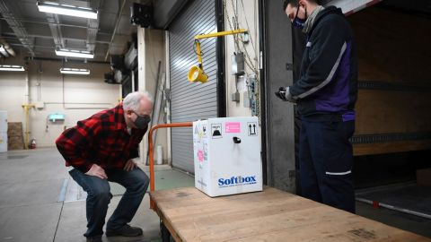 Minnesota Gov. Tim Walz inspects the first delivery of the Pfizer-BioNTech COVID-19 vaccines to the Minneapolis VA Hospital on Monday, Dec. 14, 2020.