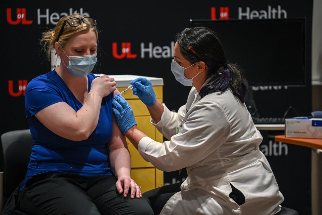 Beth Sum, a registered nurse, receives a COVID-19 vaccination at University of Louisville Hospital on December 14, 2020 in Louisville, Kentucky. 