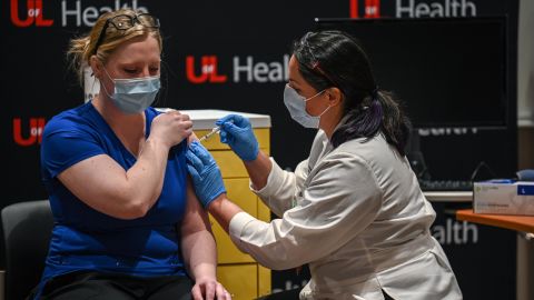 Beth Sum, a registered nurse, receives a COVID-19 vaccination at University of Louisville Hospital on December 14, 2020 in Louisville, Kentucky. 