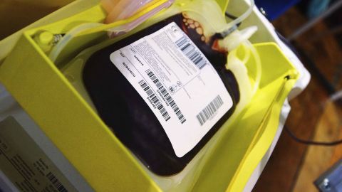 A storage bag is filled with just-donated blood at an NHS National Blood Service collection center. 