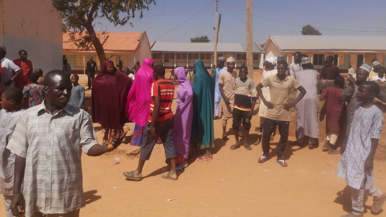 People gather at the Government Science Secondary School the day after the attack.