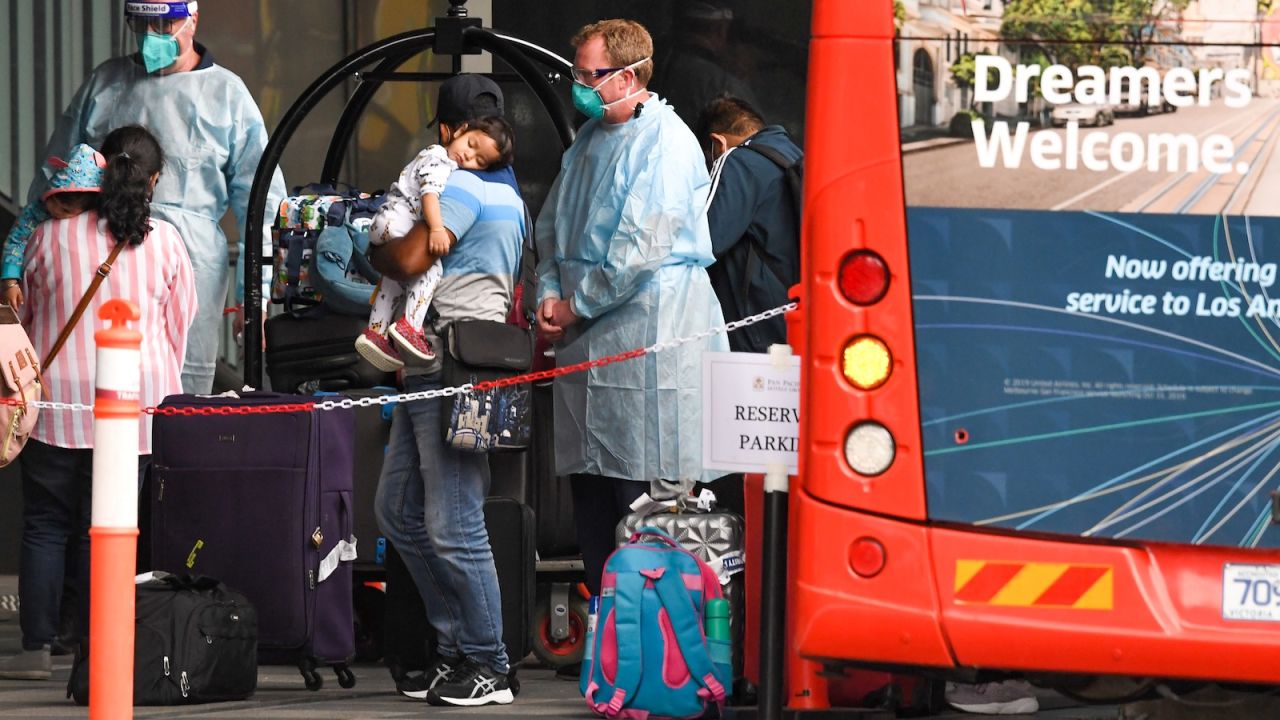 Travellers arrive at a hotel in Melbourne on December 7, 2020. Australians returning from overseas must quarantine for two weeks. 