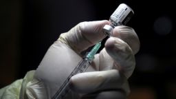 A healthcare worker prepares to administer a Pfizer/BioNTEch coronavirus disease (Covid-19) vaccine at The Michener Institute, in Toronto, Ontario on December 14, 2020. - Ontario, Canada's most populous province and one of the hardest hit by the pandemic, had 1,940 new cases and 23 deaths on Monday.  The province is expected to give its next doses to nursing home workers as a priority, according to media reports. (Photo by CARLOS OSORIO / POOL / AFP) (Photo by CARLOS OSORIO/POOL/AFP via Getty Images)
