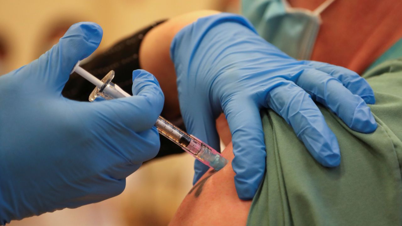 Derek Thompson, a personal support worker, is inoculated with the  Pfizer/BioNTEch coronavirus disease (Covid-19) vaccine at The Michener Institute, in Toronto, Ontario on December 14, 2020. - Ontario, Canada's most populous province and one of the hardest hit by the pandemic, had 1,940 new cases and 23 deaths on Monday.  The province is expected to give its next doses to nursing home workers as a priority, according to media reports. (Photo by CARLOS OSORIO / POOL / AFP) (Photo by CARLOS OSORIO/POOL/AFP via Getty Images)