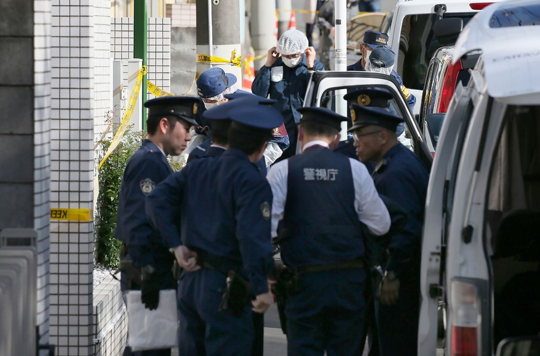 Policemen prepare for inspection in front of an apartment in Zama, Kanagawa prefecture, on November 2, 2017, where police found nine dismembered corpses.