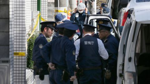 Policemen prepare for inspection in front of an apartment in Zama, Kanagawa prefecture, on November 2, 2017, where police found nine dismembered corpses.