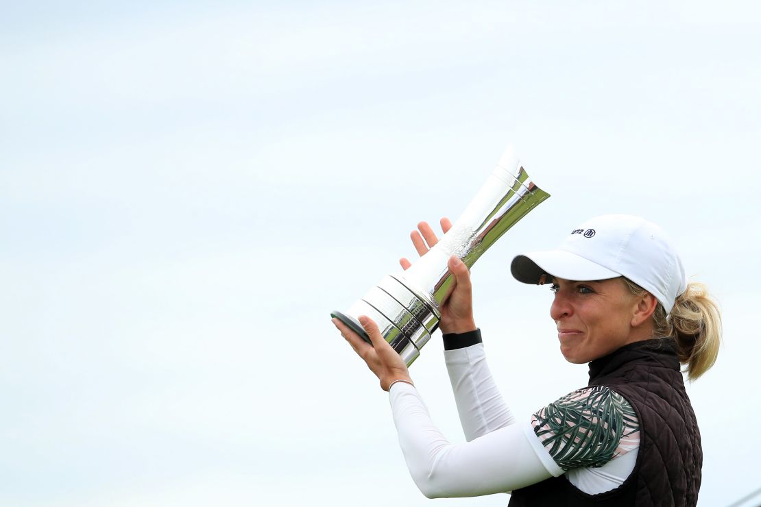 Popov lifts the trophy following victory at the Women's British Open.