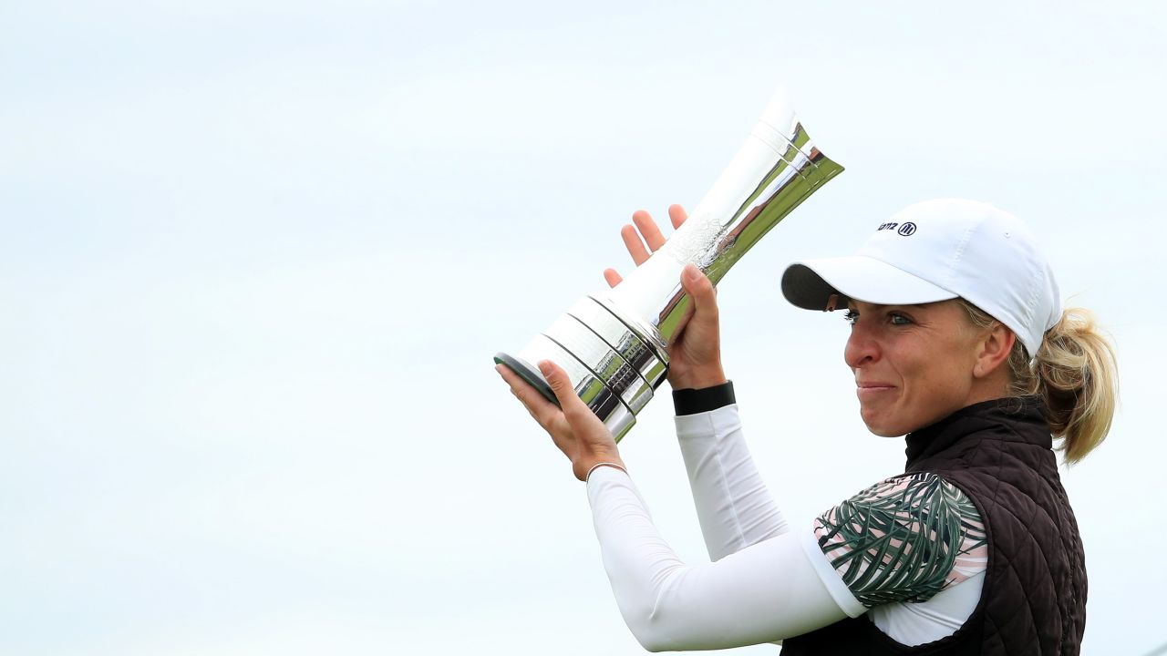 Popov lifts the trophy following victory at the Women's British Open.