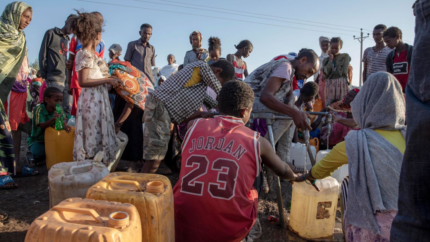 A refugee who fled the conflict in the Ethiopia's Tigray fills his gallon with water at Hamdeyat Transition Center near the Sudan-Ethiopia border, eastern Sudan on December 3