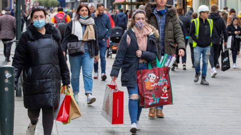 Pedestrians walk along a busy shopping street in Dublin on December 1