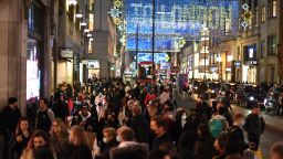 Christmas illuminations are seen above shoppers on Regent Street, London on December 15