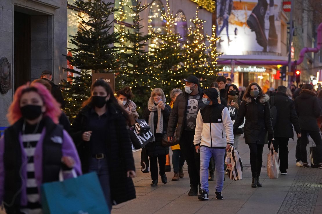 Shoppers crowd under Christmas lights in Berlin on December 15.