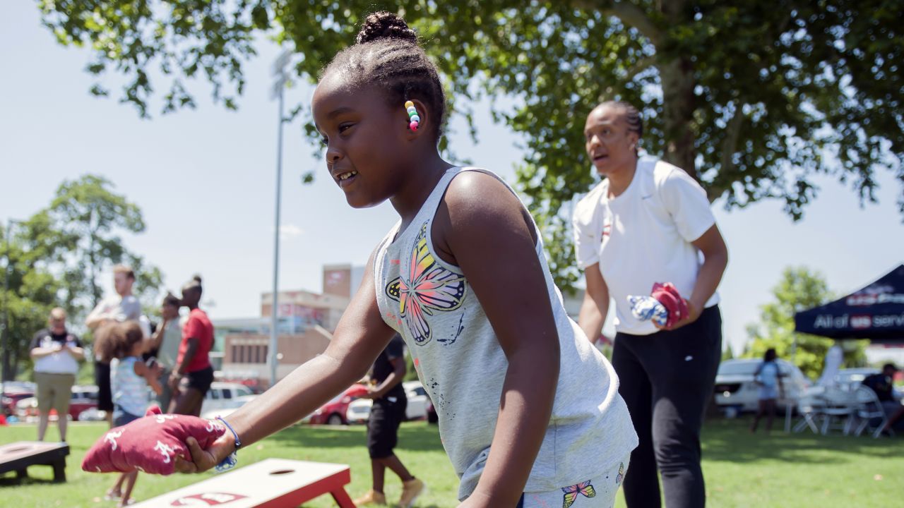 Layla Sarver, 6, plays cornhole with Western Kentucky University freshman basketball player Victoria Hunter, July 24, 2019, during United Way of Southern Kentucky's Day of Caring in Bowling Green, Kentucky.