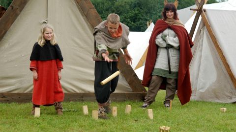 In Oldenburg, Germany, children play kubb in the archaeological project Slawenland (Slav land), a rebuilt historic camp of the Vikings and Slavs.