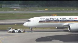 Singapore Airlines passenger plane is towed to the terminal area of Changi International Airport in Singapore on December 7, 2020. (Photo by Roslan RAHMAN / AFP) (Photo by ROSLAN RAHMAN/AFP via Getty Images)