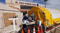 ER tech Brenda de la Cruz (R) and RN Janet Hays works outside St Mary Medical Center in the triage tents as they handle the overflow at its 200 bed hospital during the outbreak of the coronavirus disease (COVID-19) in Apple Valley, California, U.S., December 8, 2020.  REUTERS/Mike Blake