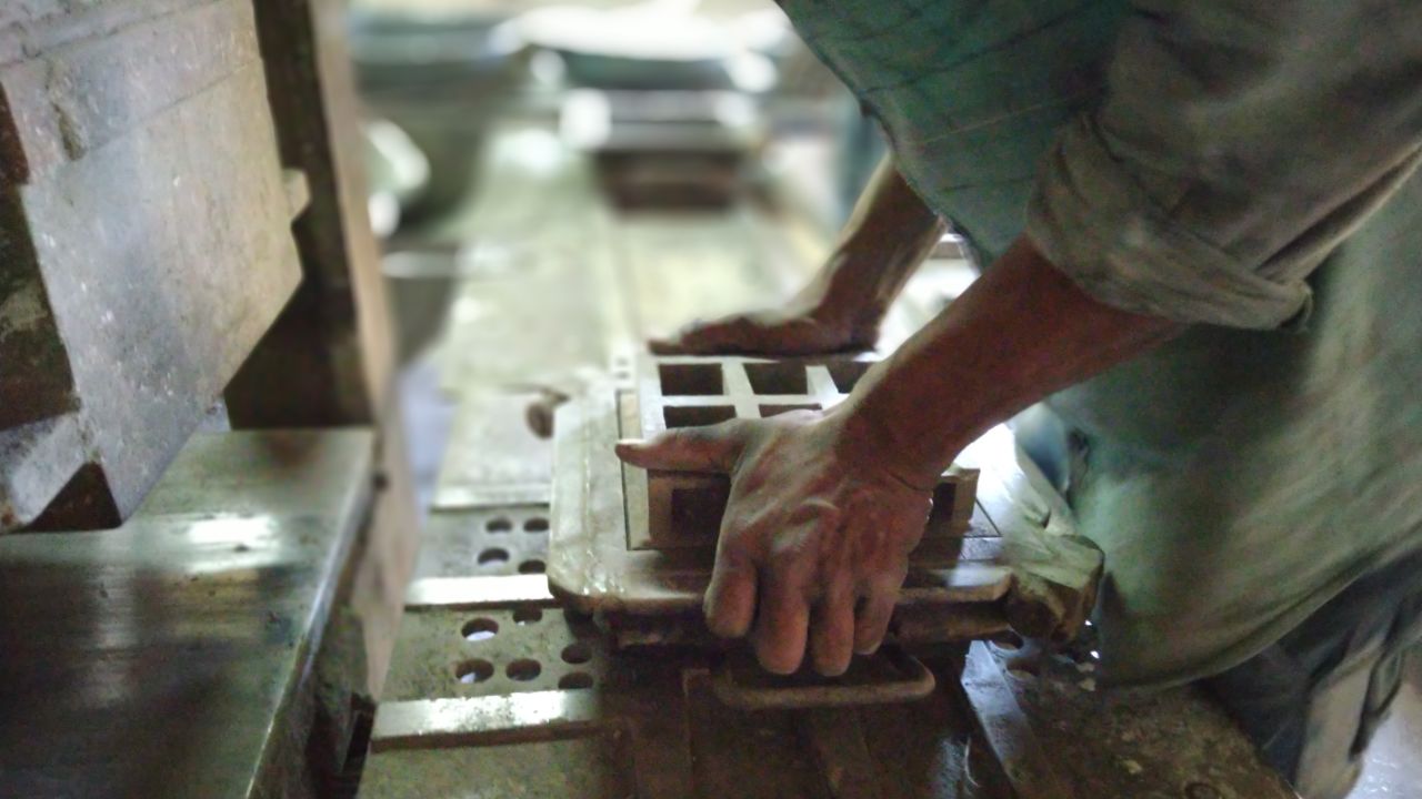 Carbon Craft Design uses a hydraulic press to mold carbon, marble and cement into a monochromatic tile.