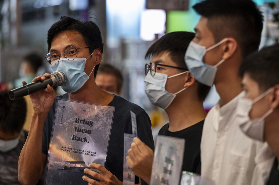 Pro-democracy activists Eddie Chu, Joshua Wong, Owen Chow and Lester Shum distribute leaflets in support of 12 activists who tried to flee to Taiwan. 