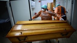 Workers at a funeral home move coffins with bodies of Covid-19 victims during the second wave of the coronavirus pandemic in the state of Saxony on  December 7, 2020 in Annaberg-Buchholz, Germany. Saxony currently has the highest concentration of high coronavirus infection rates nationwide, with 10 of its 12 counties recording infection rates of well over 200 per 100,000 over seven days. Its three eastern-most counties of Bautzen, Goerlitz and Saxon Switzerland/Eastern Ore Mountains are averaging over 450. Nationwide Germany is struggling to bring down infection rates that have been averaging around 18,000 per day since October, with daily death rates averaging around 380.
