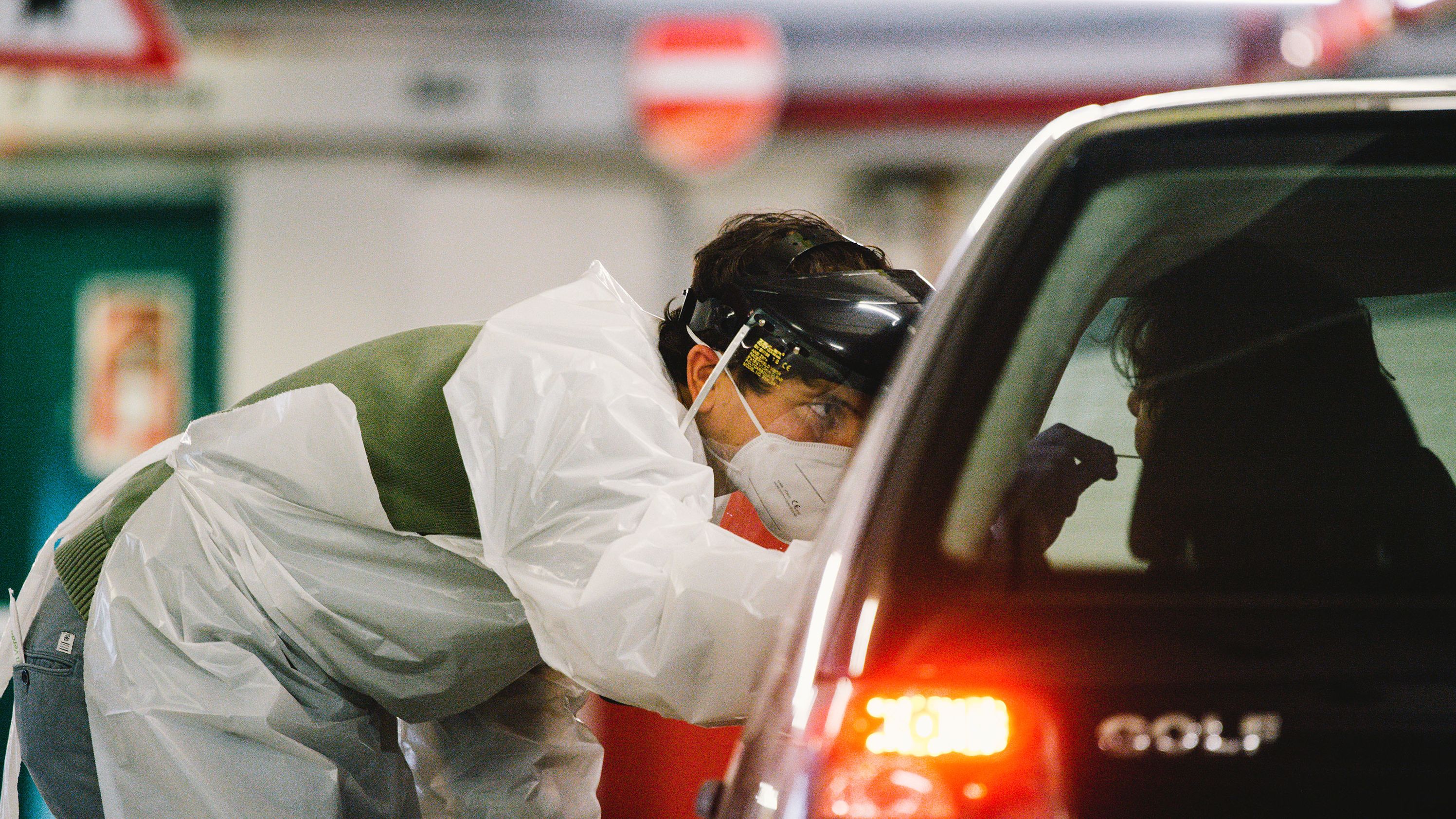 Medical workers administer antigen tests at Lanxess arena parking lot in Cologne, Germany, on December 14. 