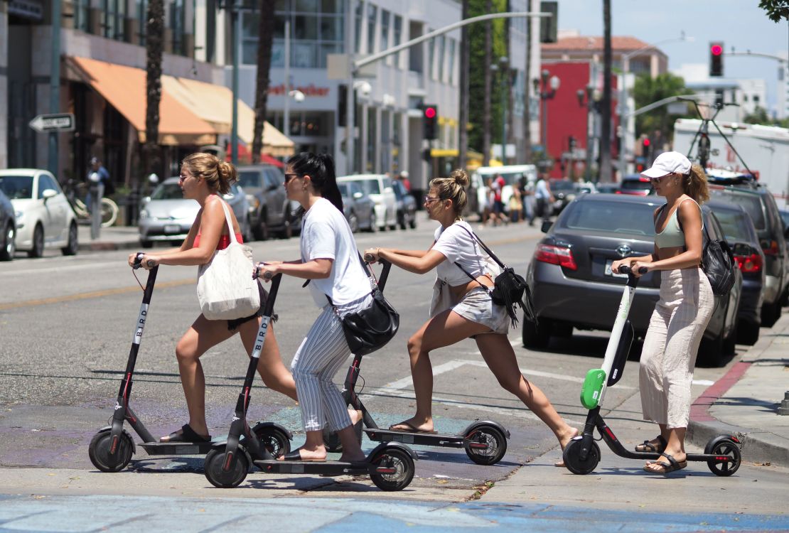 Women ride shared electric scooters in Santa Monica, California, in July 2018. 