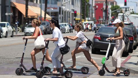 Women ride shared electric scooters in Santa Monica, California, in July 2018. 