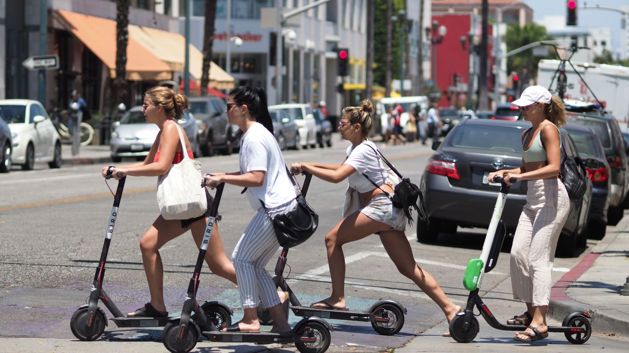 Women ride shared electric scooters in Santa Monica, California, in July 2018.