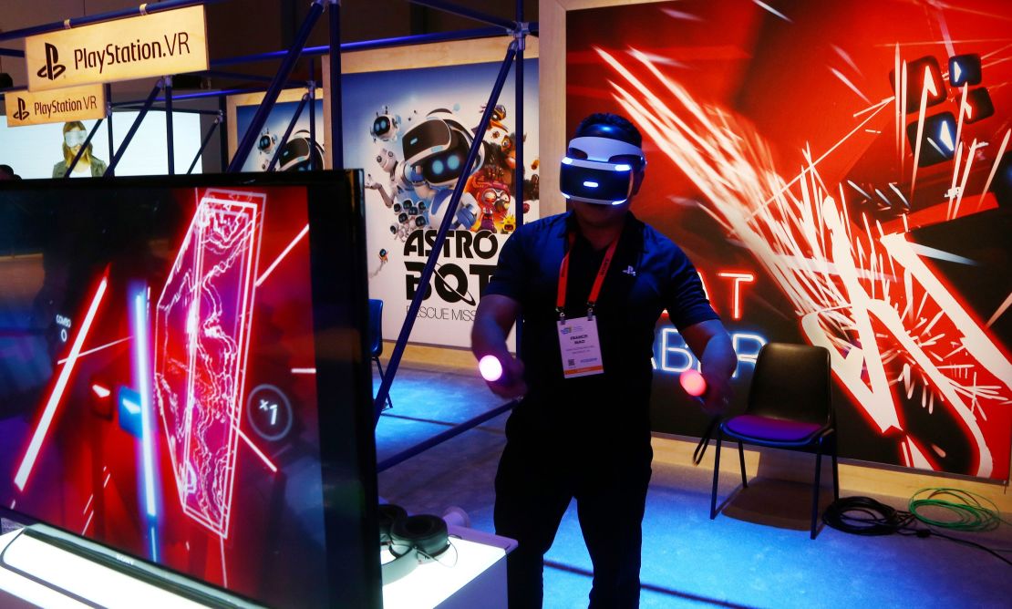 An  attendee plays the PlayStation virtual reality Beat Saber game at the Consumer Electronics Show International, January 7, 2019, in Las Vegas.