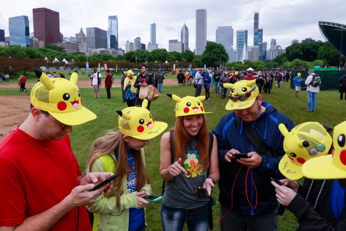 Tina Kellock (center) of Phoenix,  participates with family and friends at the Pokémon Go Fest 2019 in Chicago's Grant Park, June 13, 2019.