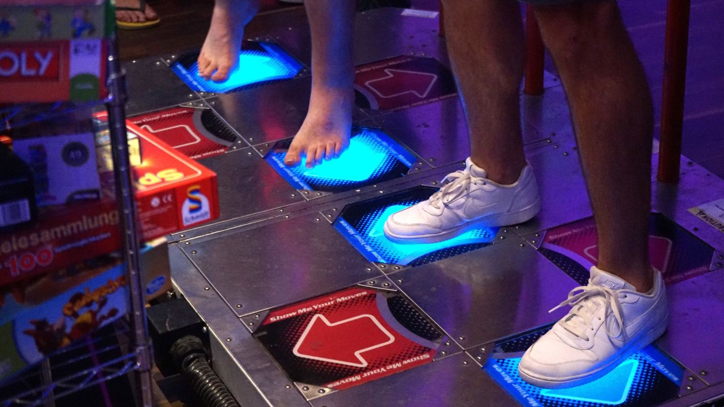 Visitors at the e-sport tournament "Homestory Cup" get ready to move by playing "Dance Dance Revolution" in Krefeld, Germany, on June 29, 2019.