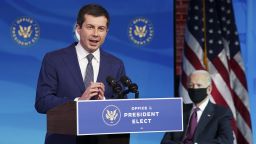 Former South Bend, Indiana Mayor Pete Buttigieg, US President-elect Joe Biden's nominee to be secretary of transportation, reacts to his nomination as Biden looks on during a news conference at Biden's transition headquarters in Wilmington, Delaware, on December 16, 2020. (Photo by Kevin Lamarque/Pool/AFP/Getty Images)