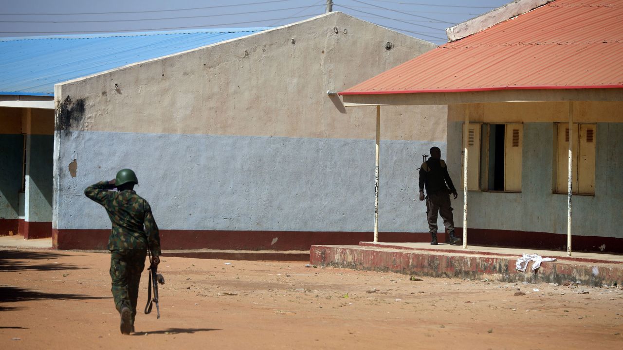 Nigerian soldiers walk inside the school on December 15, where gunmen abducted students in Kankara, Nigeria.