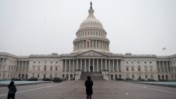 People walk past the US Capitol in Washington, DC on December 16, 2020. 