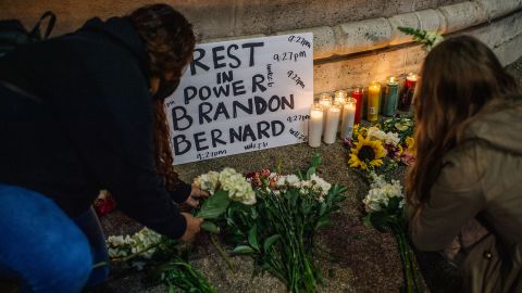 Women lay flowers at a candlelight vigil for Brandon Bernard on December 13 in Los Angeles. Bernard, 40, was the youngest person to be executed in the US in nearly 70 years, and was put to death for a crime committed when he was a teenager.
