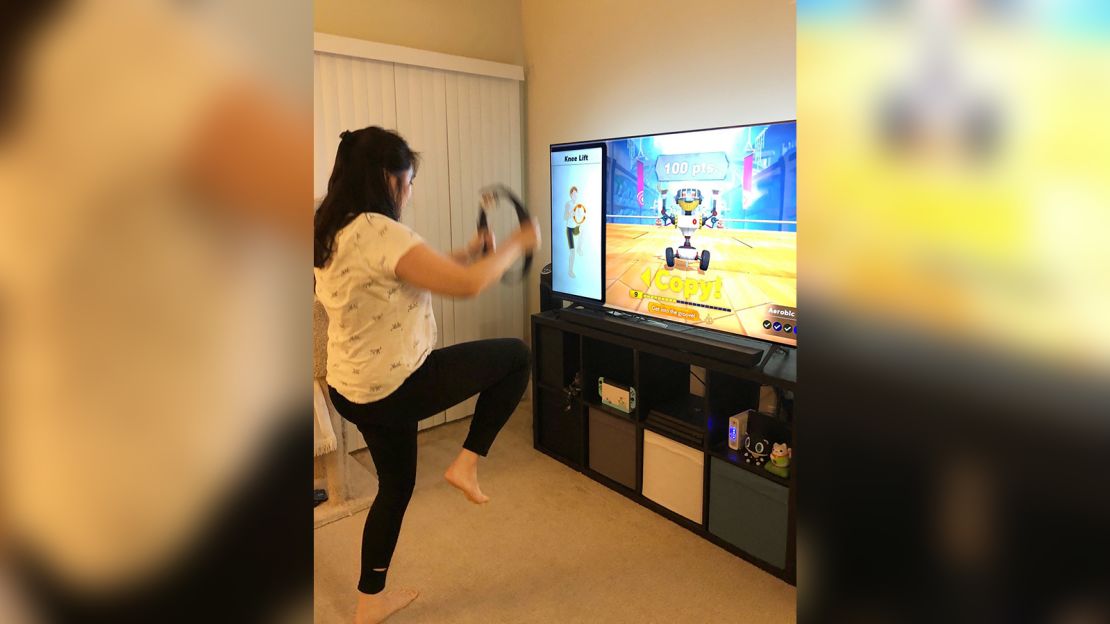 Bay Area resident Hweimi Tsou works out at home with Ring Fit Adventure on Nintendo Switch. Here she does knee lifts.
