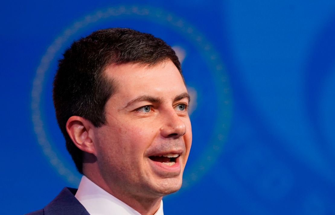 Former South Bend, Indiana Mayor Pete Buttigieg, US President-elect Joe Biden's nominee to be secretary of transportation, reacts to his nomination as Biden looks on during a news conference at Biden's transition headquarters in Wilmington, Delaware, on December 16, 2020. (Photo by KEVIN LAMARQUE / POOL / AFP) (Photo by KEVIN LAMARQUE/POOL/AFP via Getty Images)