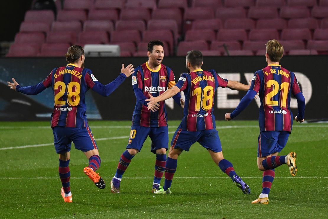 Jordi Alba celebrates with Messi after scoring Barcelona's opening goal.