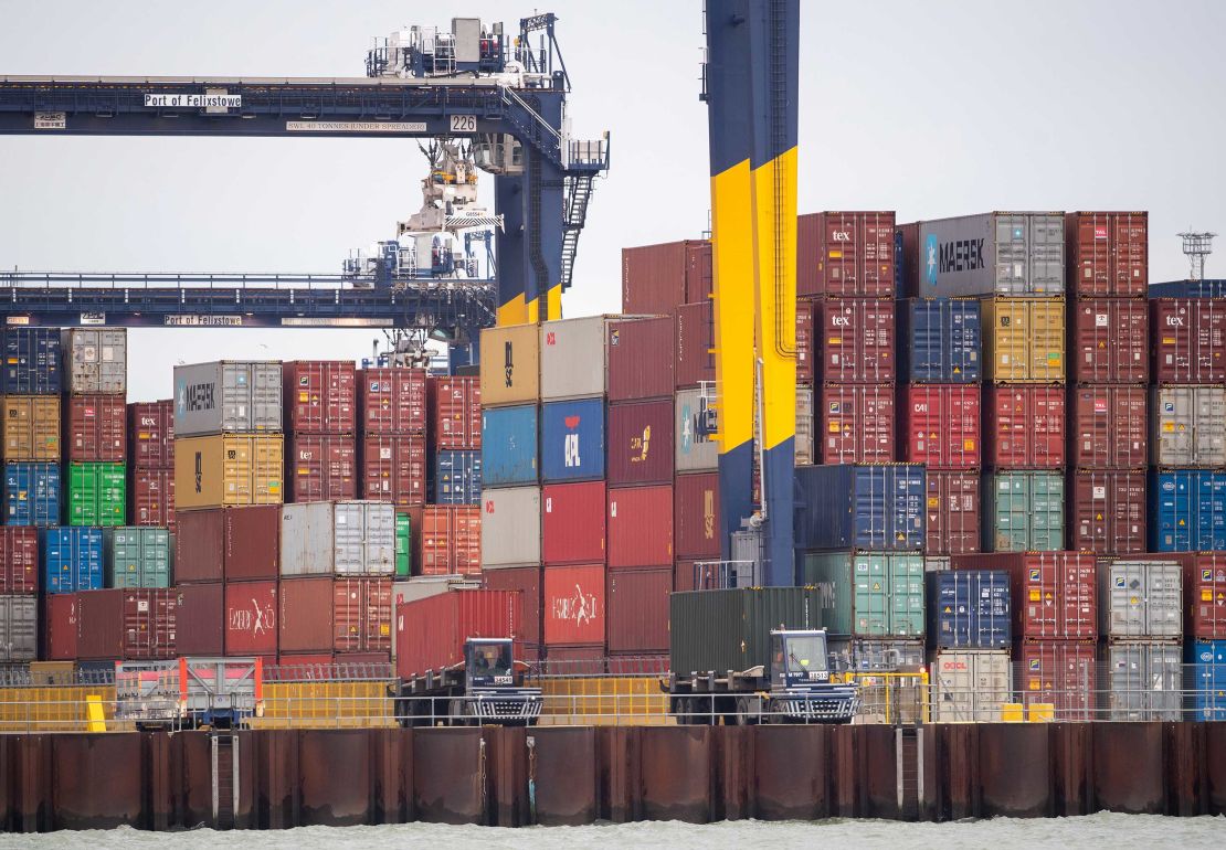 Shipping containers are unloaded from a cargo ship at the Port of Felixstowe in Suffolk on December 13.