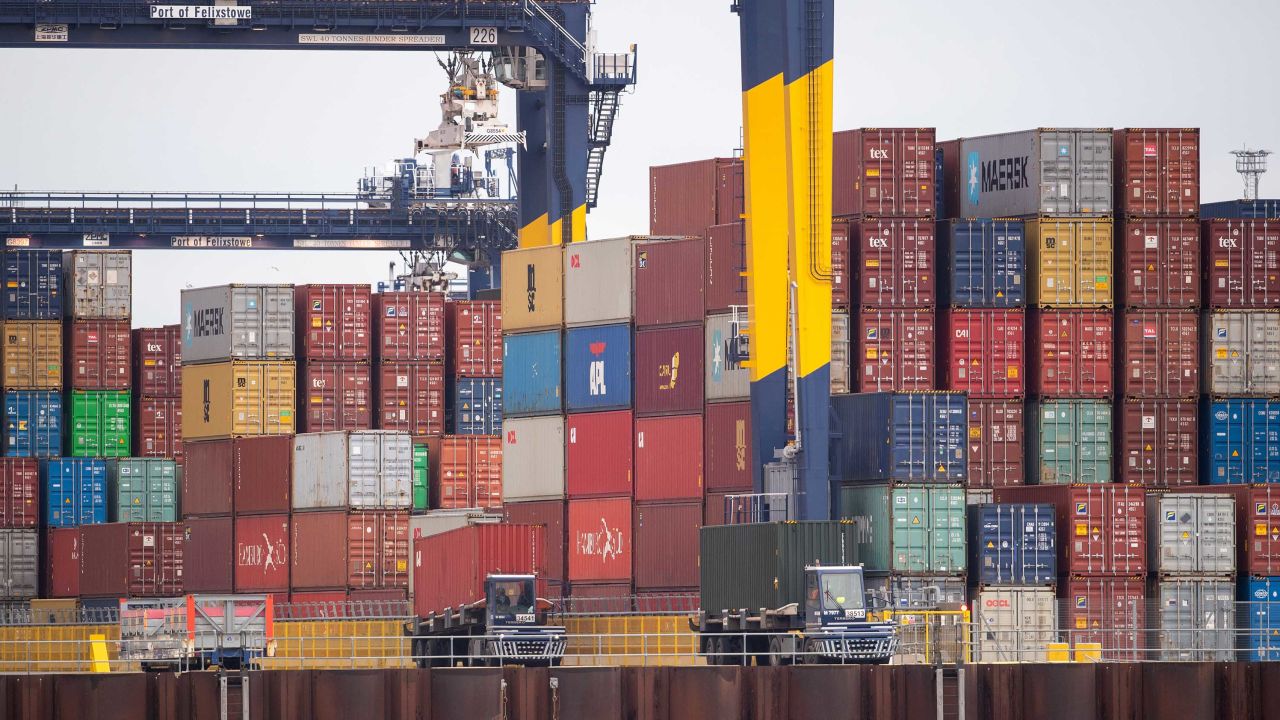 Shipping containers are unloaded from a cargo ship at the Port of Felixstowe in Suffolk on December 13.